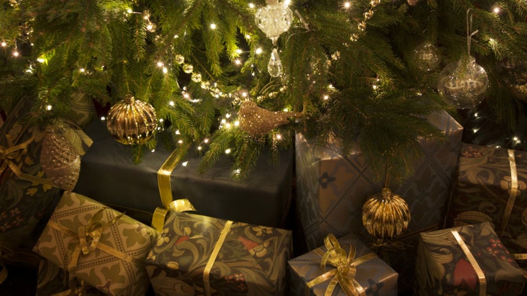 Wrapped presents underneath a sparkling Christmas tree